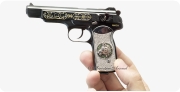 Stechkin APS Pistol, M1951 miniature model decorated with diamonds in hand